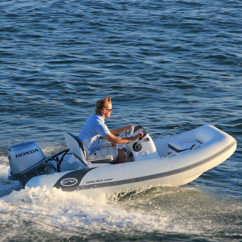 Outboard inflatable boat - 325 STX Deluxe - Walker Bay Boats - rigid / open / side console